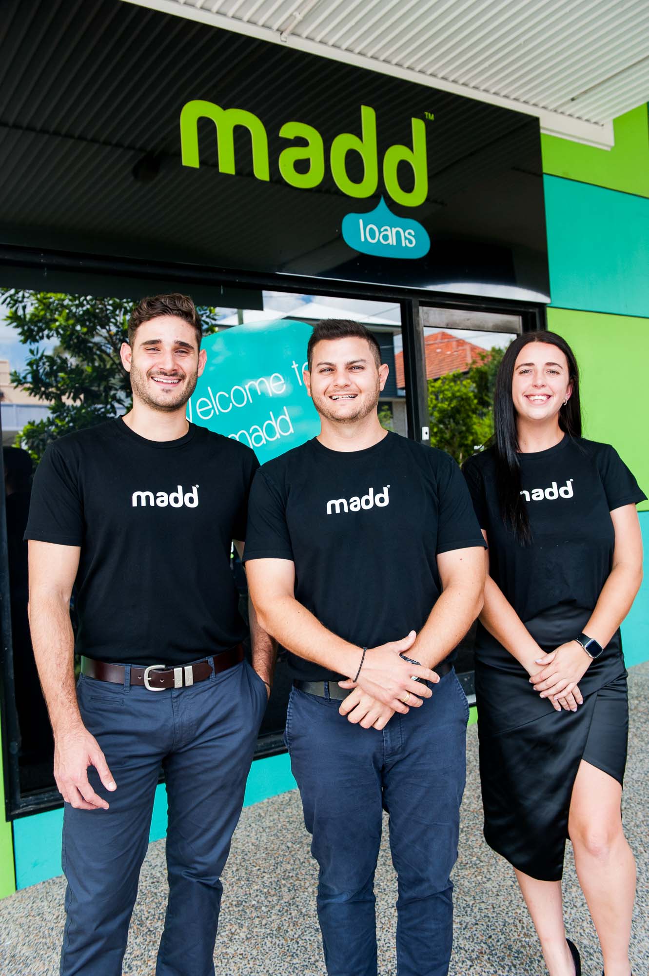 Dedicated Madd Loans staff ready to assist with financial hardship solutions, standing outside their welcoming office.